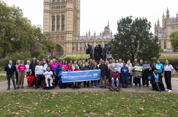 A group of over 60 campaigners gather outside parliament with messages calling on the government not to forget social care.at the upcoming Budget.